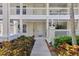 Inviting entrance with lush landscaping and a charming walkway leading to the front door at 3702 54Th W Dr # 103, Bradenton, FL 34210