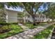 Charming two-story condo with mature trees, beautiful landscaping, and inviting walkways at 3702 54Th W Dr # 103, Bradenton, FL 34210