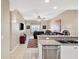 Modern kitchen with stainless steel appliances overlooking the living room with comfortable seating and a ceiling fan at 3702 54Th W Dr # 103, Bradenton, FL 34210