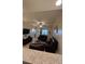 View from the kitchen to the living room, showcasing comfortable leather seating and a flat-screen TV at 3702 54Th W Dr # 103, Bradenton, FL 34210