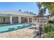 Clean community pool with blue water and plenty of deck seating surrounded by lush landscaping at 3702 54Th W Dr # 103, Bradenton, FL 34210