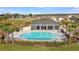 Aerial view of the community pool and lounge area, surrounded by landscaping and seating at 4005 Direct Green Pl, Bradenton, FL 34208