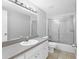 Bathroom featuring a single sink vanity and a shower-tub combination with sliding doors at 4027 Dyer Ln, Sarasota, FL 34232