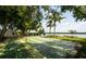 Community shuffleboard court near the water, surrounded by mature trees and picnic tables at 4440 Exeter Dr # 103, Longboat Key, FL 34228
