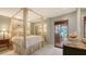 Comfortable bedroom featuring a canopy bed, mirrored closet doors, and bright natural light at 5055 Gulf Of Mexico Dr # 331, Longboat Key, FL 34228