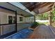 Covered back porch with a ceiling fan and wood flooring detail leading to the backyard at 51 Webb St, Osprey, FL 34229
