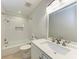 This bathroom features a shower-tub, white tiled walls, and a single sink at 51 Webb St, Osprey, FL 34229