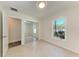 This bedroom features neutral walls, tiled floors, closet, and a window with a lush view at 51 Webb St, Osprey, FL 34229