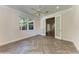 Bright bedroom with herringbone floors, a ceiling fan, and stylish glass panel doors at 51 Webb St, Osprey, FL 34229