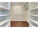 Spacious walk-in closet with custom white shelving and beautiful hardwood floors at 51 Webb St, Osprey, FL 34229