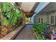 Inviting outdoor deck area with lush tropical landscaping and shade coverings at 51 Webb St, Osprey, FL 34229