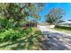 A beautiful home featuring lush landscaping, mature trees, and a spacious two-car garage at 51 Webb St, Osprey, FL 34229