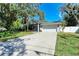 Charming single-story home with a well-manicured lawn, screened entrance, and an attached two-car garage at 51 Webb St, Osprey, FL 34229