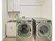 This laundry room features a sink, upper cabinets, a washer, and a dryer at 51 Webb St, Osprey, FL 34229