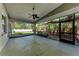 This screened-in patio offers views of the green backyard with a deck and mature landscaping at 51 Webb St, Osprey, FL 34229