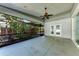This spacious screened-in patio offers shade with a ceiling fan and views of the landscaped backyard at 51 Webb St, Osprey, FL 34229