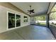 The sliding glass door opens up to this screened-in patio that overlooks a lush backyard at 51 Webb St, Osprey, FL 34229