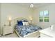 Cozy bedroom with a white bed frame, floral bedding, and plantation shutters over the window at 5220 Hyland Hills Ave # 1211, Sarasota, FL 34241