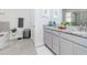 Bright bathroom with double sink vanity, large mirror, and tiled floor at 5277 Grove Mill Loop, Bradenton, FL 34211