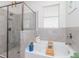 Modern bathroom features tiled shower, soaking tub, and stylish fixtures at 5277 Grove Mill Loop, Bradenton, FL 34211
