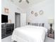 Bedroom features modern decor, a black dresser, and a queen bed with a stylish side table at 5277 Grove Mill Loop, Bradenton, FL 34211
