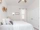 Bright bedroom features a ceiling fan, double door closet, natural light, and serene decor at 5277 Grove Mill Loop, Bradenton, FL 34211