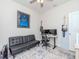 A view of the bonus room offering a comfortable couch, desk and decor at 5277 Grove Mill Loop, Bradenton, FL 34211