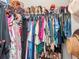 Walk-in closet with extensive storage, with double hanging rods and shelves for organization at 5277 Grove Mill Loop, Bradenton, FL 34211