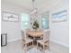 Charming dining area with modern lighting fixture, gather sign, and natural light at 5277 Grove Mill Loop, Bradenton, FL 34211