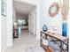 Bright entryway with a decorative table, mirror, and an open view into the living space at 5277 Grove Mill Loop, Bradenton, FL 34211