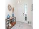 Stylishly decorated entryway featuring a console table, decorative mirror, and neutral tones at 5277 Grove Mill Loop, Bradenton, FL 34211