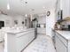 Spacious kitchen featuring a large island with seating and modern appliances and finishes at 5277 Grove Mill Loop, Bradenton, FL 34211