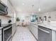 Updated kitchen with stainless steel appliances, granite countertops, and a view to the dining area at 5277 Grove Mill Loop, Bradenton, FL 34211