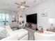 Bright living room featuring a large sectional, ceiling fan, and entertainment center at 5277 Grove Mill Loop, Bradenton, FL 34211