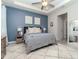 This spacious main bedroom features a large bed, a soft rug, and a blue accent wall at 5277 Grove Mill Loop, Bradenton, FL 34211