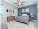 Spacious main bedroom featuring a tray ceiling, accent wall, and ample natural light at 5277 Grove Mill Loop, Bradenton, FL 34211