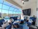 A screened-in patio with comfortable blue seating overlooks a serene water view and refreshing pool at 5277 Grove Mill Loop, Bradenton, FL 34211