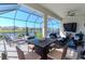 Covered patio featuring a tranquil water view, a refreshing pool, plus lounge and dining areas at 5277 Grove Mill Loop, Bradenton, FL 34211