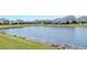 Scenic view of the community pond surrounded by meticulously landscaped lawns and beautiful nearby homes at 5277 Grove Mill Loop, Bradenton, FL 34211
