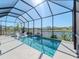 Screened-in pool offers a serene water view, with lounge chairs and lush landscaping at 5277 Grove Mill Loop, Bradenton, FL 34211