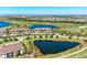 Scenic aerial view of townhomes overlooking a beautiful golf course and serene lakes in a Primary-planned community at 5577 Palmer Cir # 203, Bradenton, FL 34211