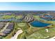 Breathtaking aerial view of a community with lush golf courses, serene lakes, and beautiful homes at 5577 Palmer Cir # 203, Bradenton, FL 34211
