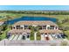 Beautiful aerial view of condo building, lake, and golf course with lush greenery and well-manicured lawns at 5577 Palmer Cir # 203, Bradenton, FL 34211