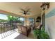 Inviting screened-in patio with comfortable seating, fan, and tropical decor at 5577 Palmer Cir # 203, Bradenton, FL 34211