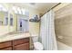Well-lit bathroom showcasing vanity with granite countertop and shower with tile surround at 5577 Palmer Cir # 203, Bradenton, FL 34211