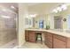 Ensuite bathroom with walk-in shower and dual vanities at 5577 Palmer Cir # 203, Bradenton, FL 34211