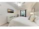 Main bedroom showcases a ceiling fan and a mounted television at 5577 Palmer Cir # 203, Bradenton, FL 34211
