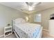 Cozy bedroom featuring a comfortable bed with floral bedding, complemented by a side table and neutral wall color at 5577 Palmer Cir # 203, Bradenton, FL 34211