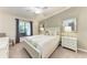 Well-lit main bedroom features a large window and decorative touches at 5577 Palmer Cir # 203, Bradenton, FL 34211