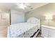 Bright bedroom featuring a queen bed, ceiling fan, and neutral walls at 5577 Palmer Cir # 203, Bradenton, FL 34211